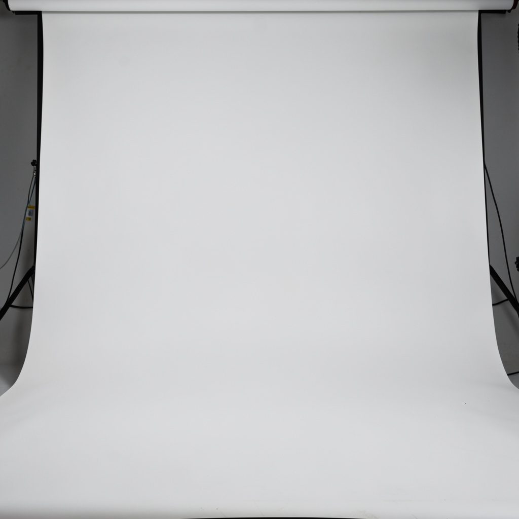 Studio close-up of a low-profile diving mask with dark frame on a clean white surface, minimalist look.